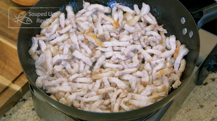 Image of Turn the heat to high and heat the wok to smoking hot. Drizzle 1/2 Tbsp of oil to lubricate the wok. Then add the pork belly. Spread it out and cook for about 5 minutes or until there is about 1/4 cup of pork...