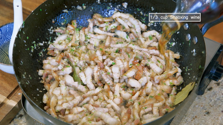 Image of Pour in 1/3 cup of Shaoxing wine and stir to deglaze the bottom. Although you could use rice wine, but Shaoxing wine makes this dish more authentic.