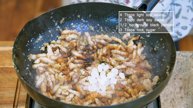 Image of Season it with 4 Tbsps of light soy sauce, 2 tbsps of dark soy sauce, some ground white pepper to taste, and 3 Tbsps of rock sugar. Rock sugar is refined and re-crystalized from regular sugar. It won't affect the taste, so you can use the same amount of table sugar instead.