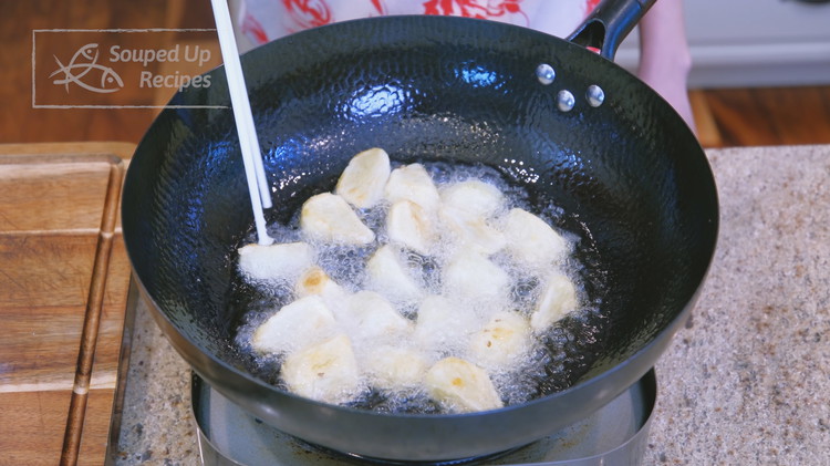 Image of Heat the oil in a wok to 360℉ / 182℃ and add the coated potatoes. Shallow-fry them until golden and crispy, about 2-3 minutes per side. Remove and set aside.
