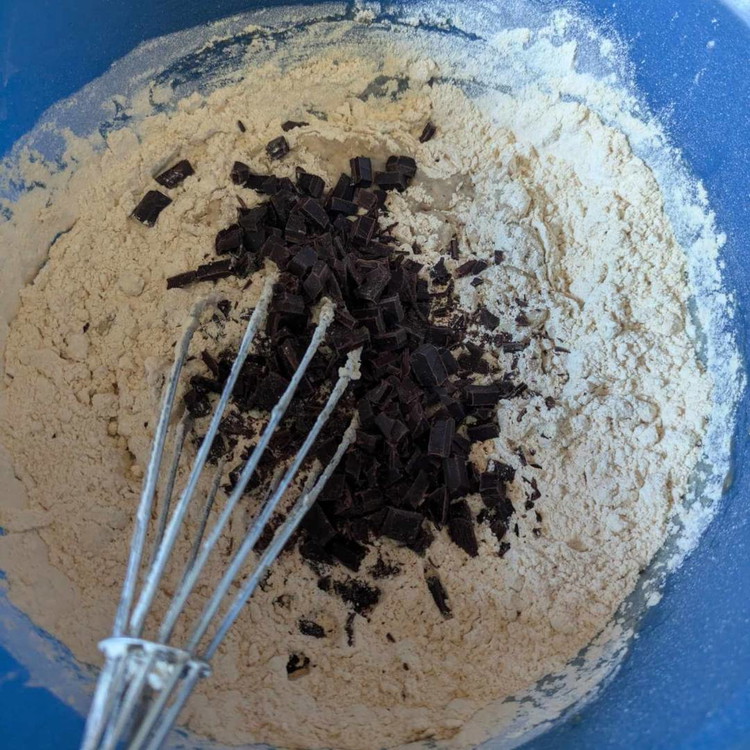 Image of Stir the dry ingredients into the wet ingredients. Mix until combined, but avoid overmixing to prevent a chewy texture.