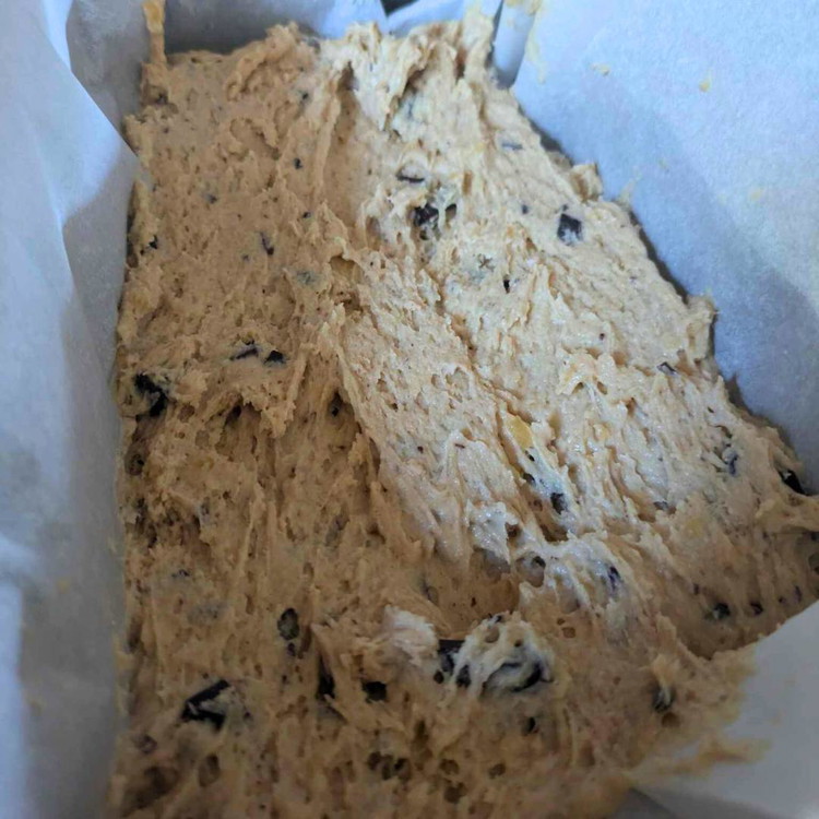 Image of Transfer the banana bread batter into the prepared loaf pan.