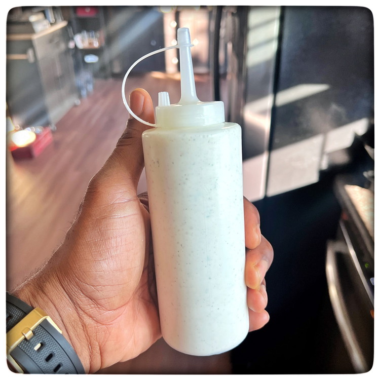 Image of Optional: Fill a plastic condiment bottle with the white sauce. This will make it easier to drizzle the sauce over the dish.