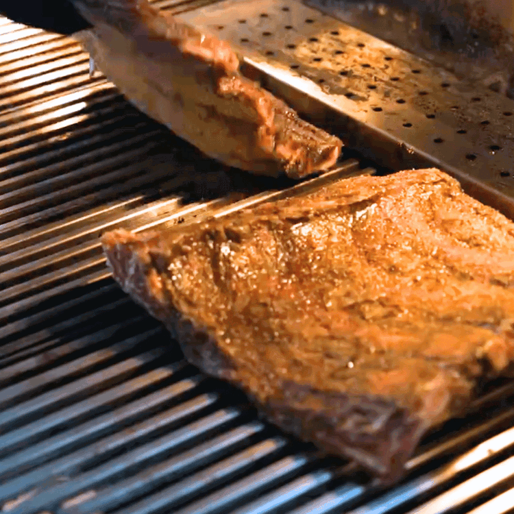 Image of Smoke the ribs for about 3-4 hours until they develop a nice bark and reach an internal temperature of around 165°F.