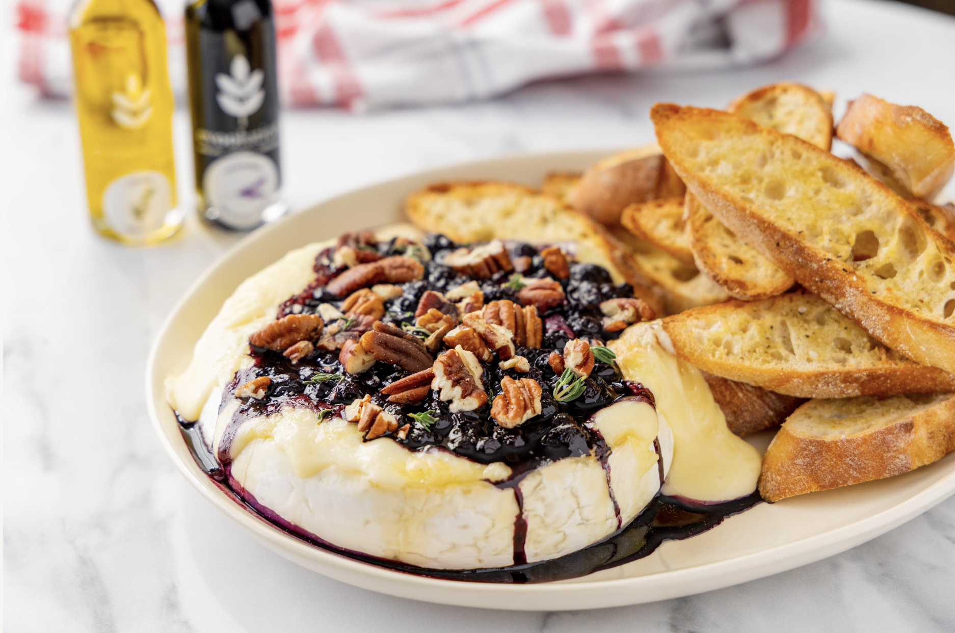 Image of Baked Brie with Blueberry Lavender Balsamic Compote and Thyme Olive Oil Crostini