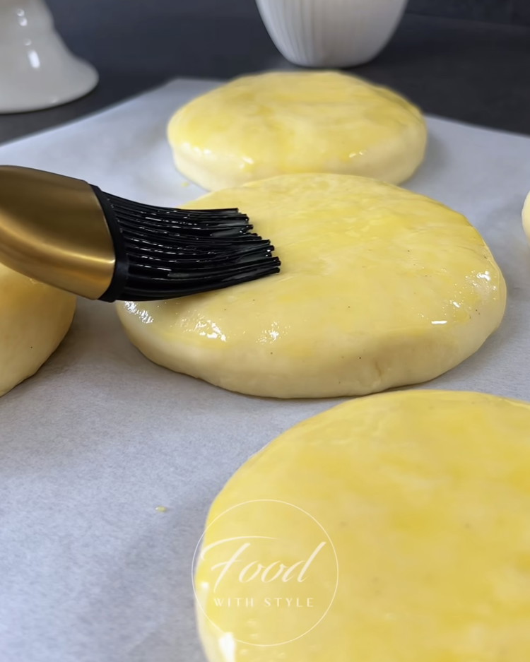 Image of Preheat the oven to 180°C (350°F). Brush the dough with the beaten egg mixture and sprinkle with pearl sugar. Bake for 15-20 minutes until golden brown, then let cool completely.
