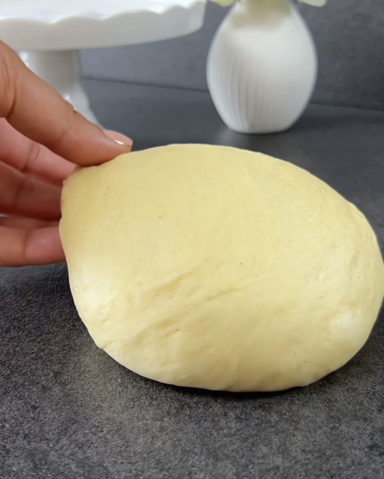 Image of Add the remaining sugar, salt, egg, butter, vanilla, and lemon zest. Pour in the rest of the milk, knead into a smooth dough, and let rise for 1 hour until doubled in size.