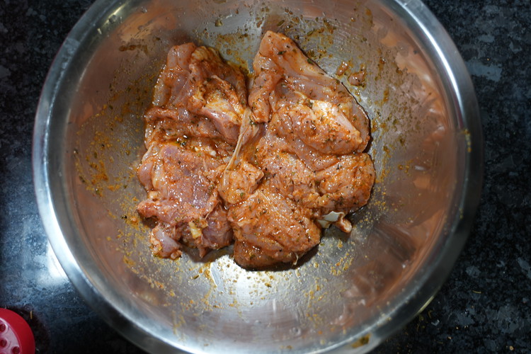 Image of Add all the ingredients listed to season the chicken to the chicken thighs mix well and allow to marinate for 15-30 minutes. 