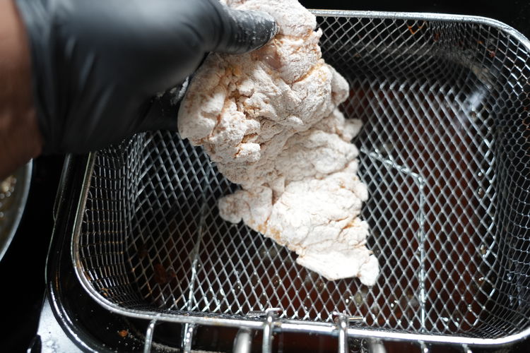 Image of Coat the seasoned chicken into the flour mix, the water...