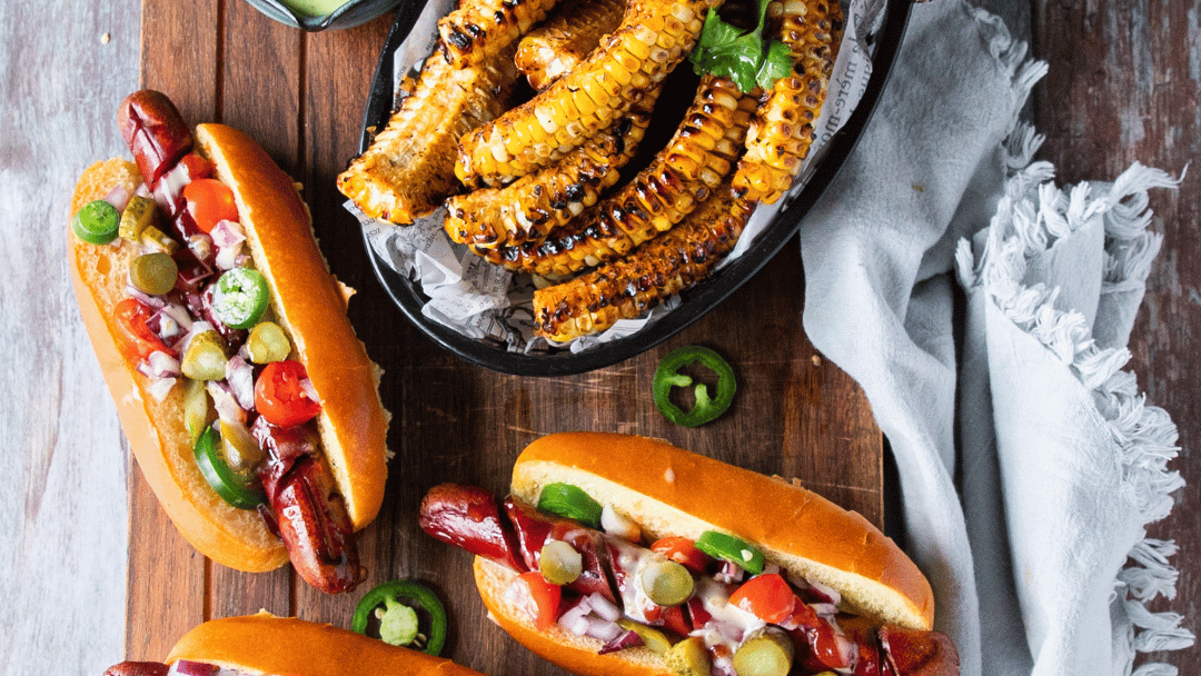 Image of Grilled Hot Dogs with Seasoned Corn Ribs and Avocado Crema