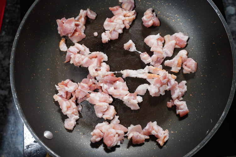 Image of Add the diced bacon to a skillet then place on the stove with the heat off. 