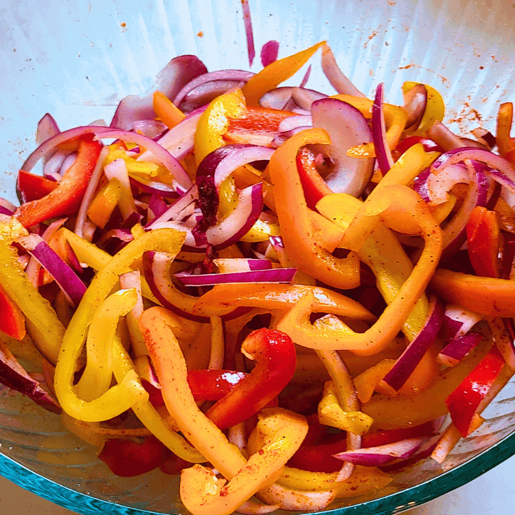 Image of Slice the onions and peppers into thin strips then toss with a tablespoon of oil, salt, pepper, a tsp of chili powder and a squeeze of lime juice. You can do this in advance and let them marinate in the...