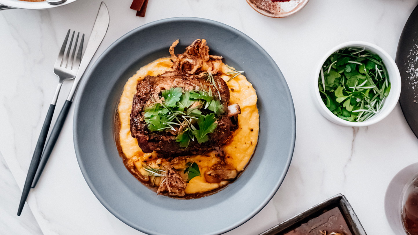 Image of Sous Vide Pork Shank with Cheddar Grits and Mustard Ale Jus