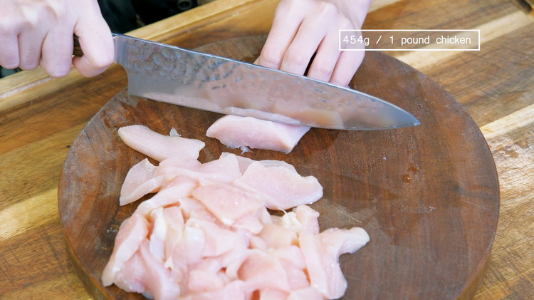 Image of Cut the chicken breast in half, then slice it into 1/3-inch thick pieces. You can also use boneless skinless chicken thighs if you prefer dark meat. 