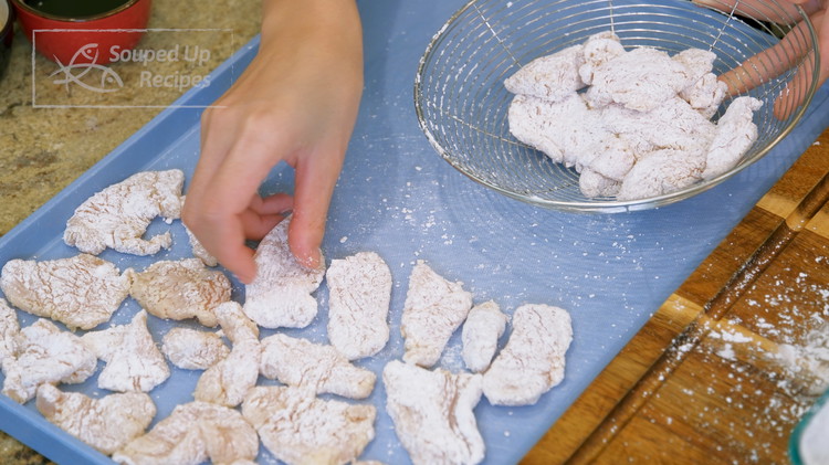 Image of Once done, let the coated chicken rest on a try for 15 minutes so the starch has enough time to bond together, and it will fall off less when deep frying.