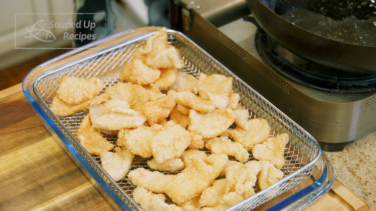 Image of Once the chicken is done frying, remove from the oil and set it aside.