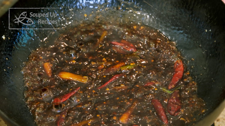 Image of Pour most of the oil out, but leave 1.5 tsp in the wok. Add minced garlic, ginger, and a white part of the scallion. Stir over medium heat for 2-3 minutes or until the aromatics are slightly golden on the...