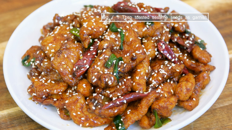 Image of Introduce the chicken back into the wok, along with the green part of the scallions. Toss everything until the chicken is coated nicely. 1 Tbsp of toasted sesame seeds. Serve with white rice.