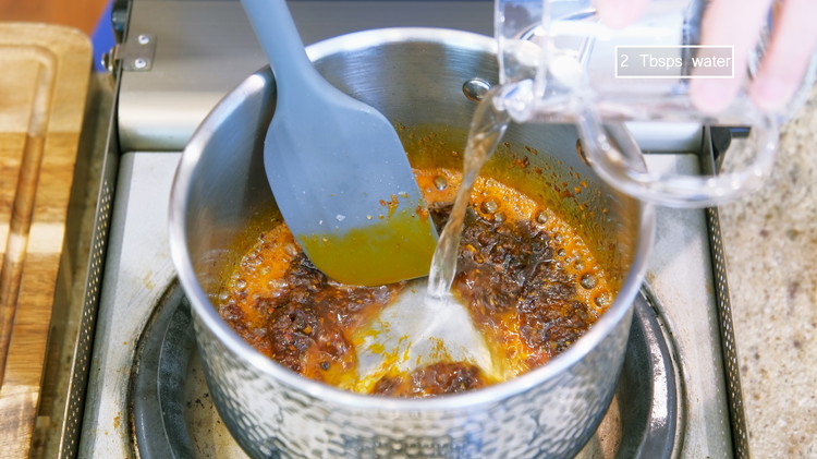 Image of Continue by adding 1 Tbsp of soy sauce, 1 Tbsp of oyster sauce, 1/2 Tbsp of Laoganma chili crisp, 1/2 Tbsp of hoisin sauce, 1/2 tsp of cumin powder, 1/2 tsp of chicken bouillon powder, and 2 tbsps of water....