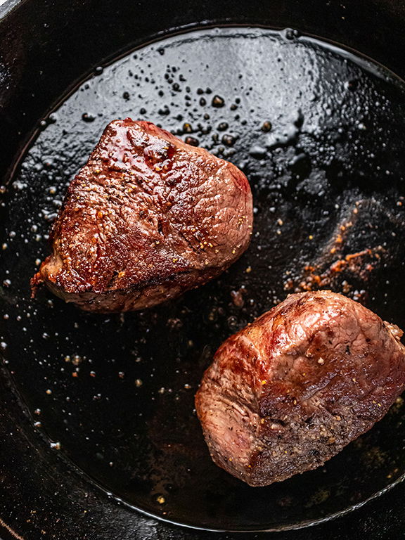 Image of Add steaks to hot skillet and sear on all 4...