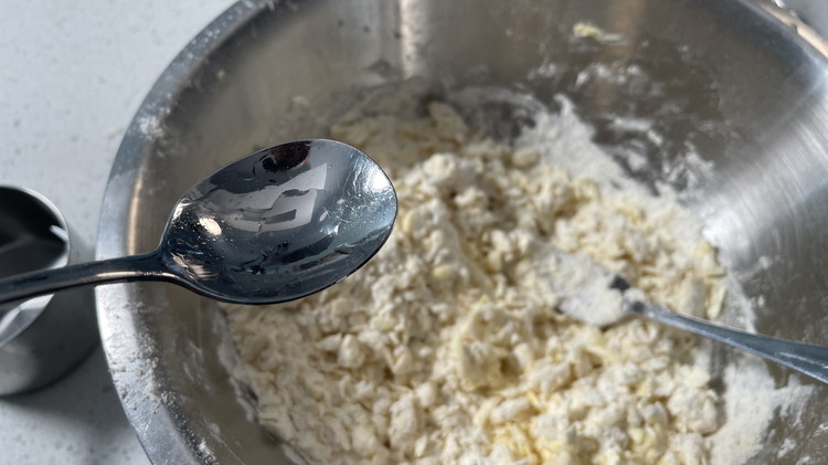Image of bang approx 6-7tbsp ice water into the mix and gently knead through. Add water until a loose crumbly dough forms