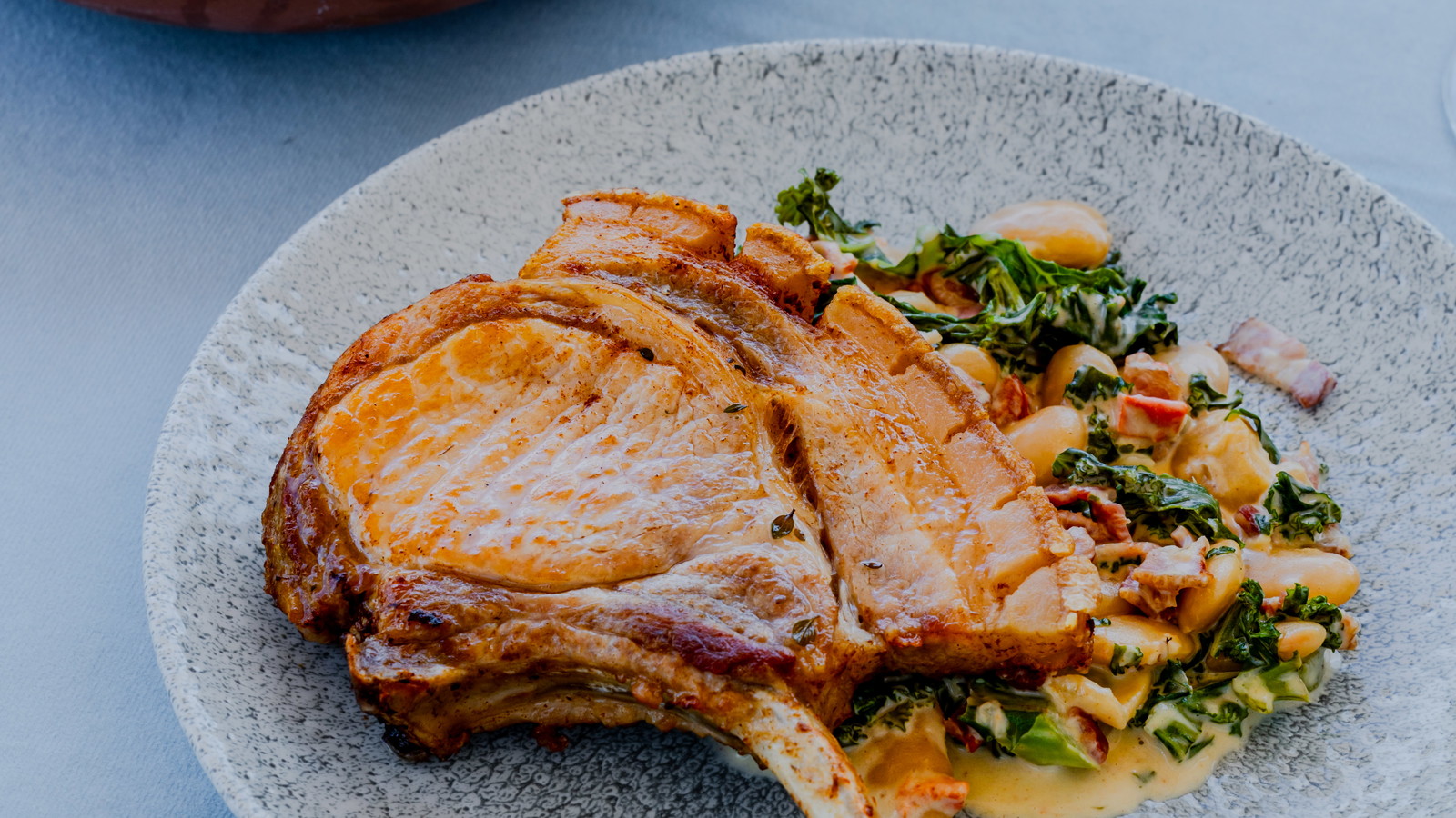 Image of French Trimmed Pork Chops With Butter Beans, Kale and Bacon