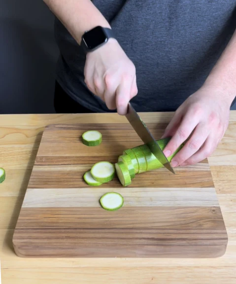 Image of Preheat your oven at 400 degrees. The key to making these crispy is by pulling the extra water out of the zucchini. Slice up your zucchini and place the slices on a paper towel. While those are drying, let’s prep...