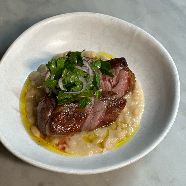 Image of roasted lamb rump with white beans & bergamot pressed olive oil