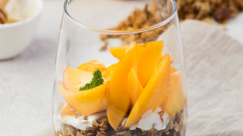 Image of Cocoa granola and peach parfait