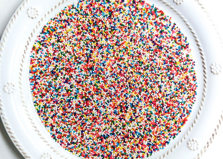 Image of Pour the rainbow nonpareil sprinkles out onto a small plate.  