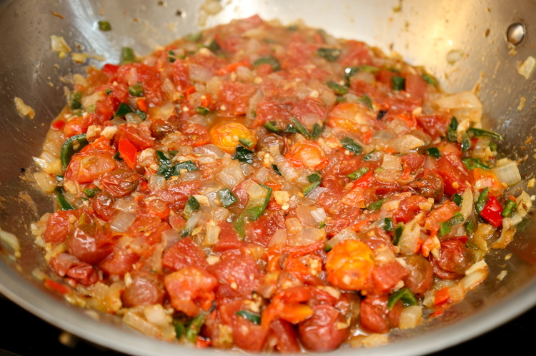 Image of Add the corriander, garam masala, and some fresh cracked black pepper and stir. After the spices are incorporated, add the cherry tomatoes, the canned tomatoes, your SPICY peppers, and some salt. Tomatoes love salt. Bring to a simmer reduce heat...