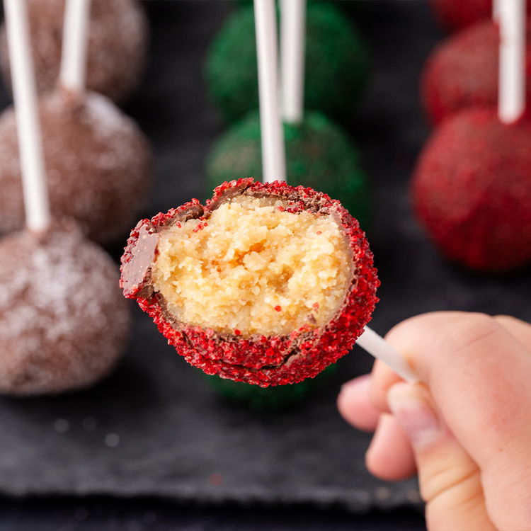 Image of Working quickly, sprinkle the cake pop with sanding sugar just before set up. Place on parchment lined baking sheet and let set up either on the side or standing straight up based on preference. Wait until chocolate is hardened until enjoying.