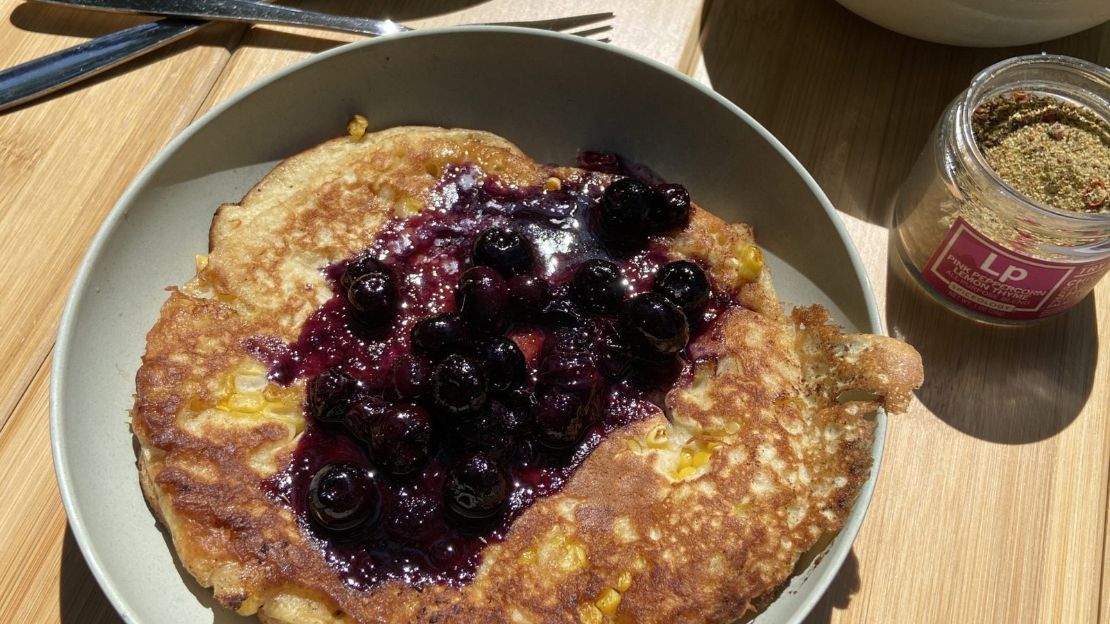 Image of Corn Pancakes with Pink Peppercorn Lemon Thyme Blueberry Syrup