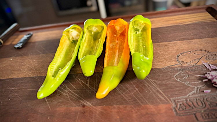 Image of On the banana chili, slice an opening on the top (or cut the stem end off and bore it out)