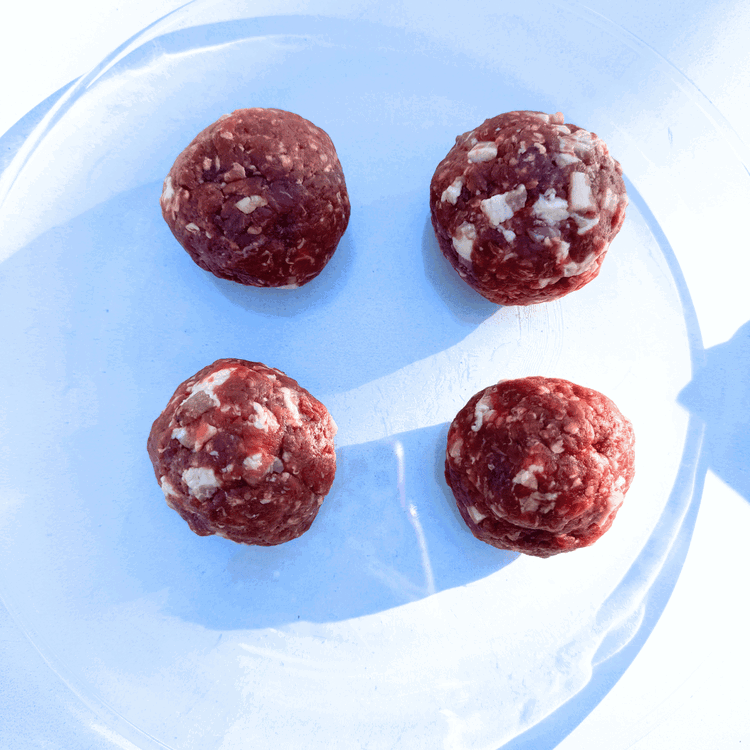 Image of Preheat a cast iron griddle. Mix the ground elk and bacon together. Form four equal size balls.