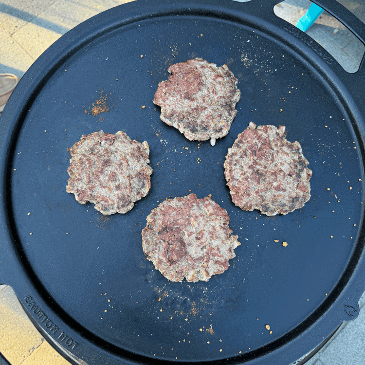 Image of After a couple minutes, flip. Add a little more seasoning to the top side of the patties. Cook them for a couple more minutes.