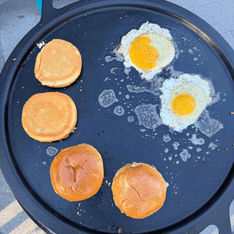 Image of Use the same cast iron to cook two eggs and toast the buns.
