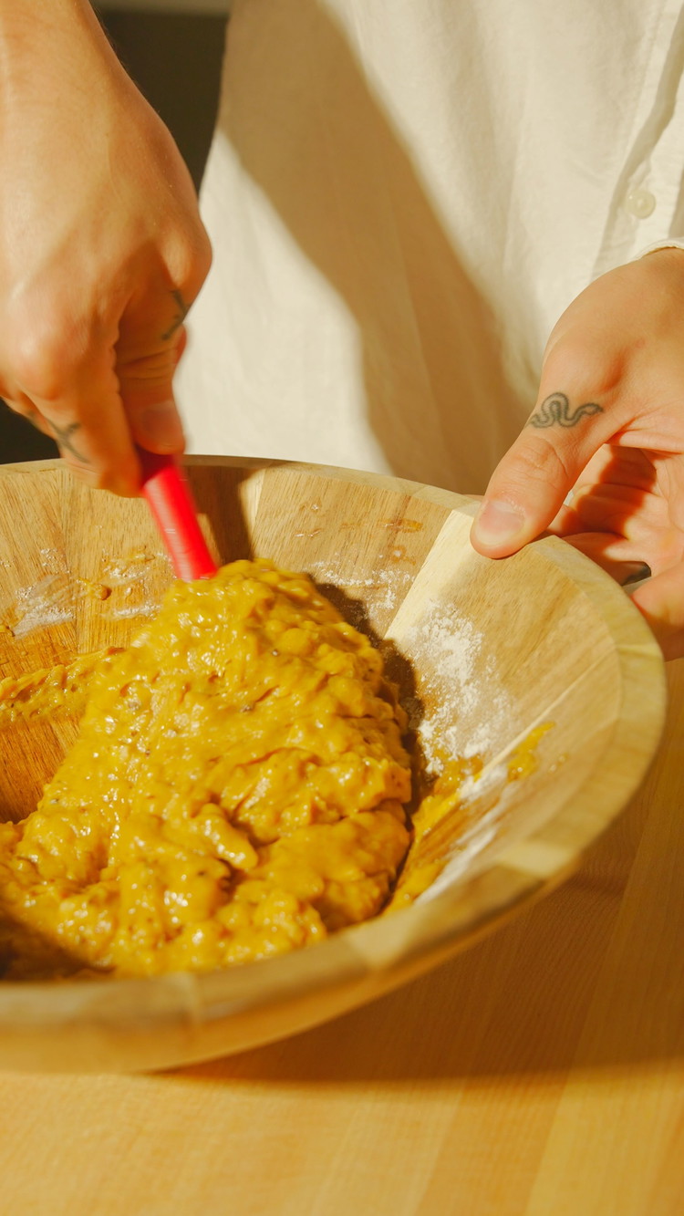 Image of Add the dry ingredients to the mix: first the flour, then sprinkle the baking soda, baking powder, salt, pumpkin spice blend, and toasted chopped pecans. Stir with a large spoon or spatula, gently, until just combined. Do not over-mix.