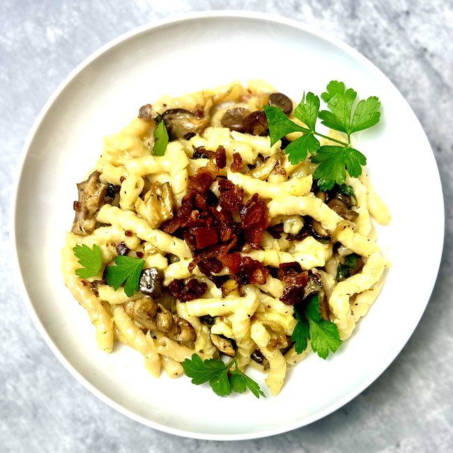 Image of creamy shiitake carbonara with crispy bacon and busiate pasta