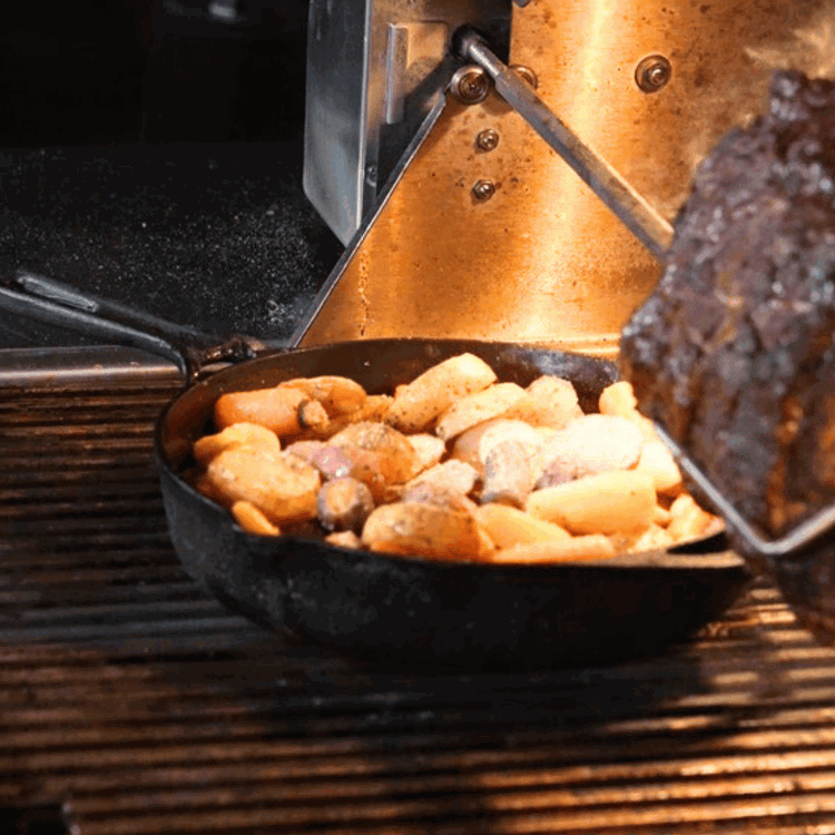 Image of Prepare Vegetables: Toss root vegetables with olive oil, salt, and pepper. Place them in a grill-safe pan and set on the grill for indirect cooking.
