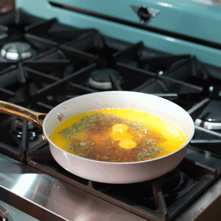 Image of In a heat proof bowl, whisk the egg yolks, lemon juice, and the strained reduction over simmering water until thickened.