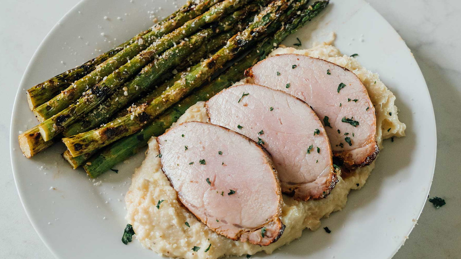 Image of Big Poppa’s Steakhouse Seasoned Pork Loin w/ Lemon Parmesan Asparagus