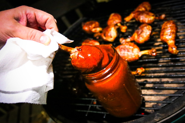 Image of After an hour it’s time for your chicken to take a sauce bath. Grab your sauce, put it in a jar that the legs will fit in leaving an inch of space at the top and start dunking your legs....