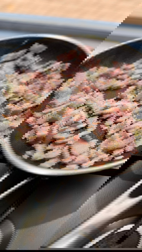 Image of Sautée the onion and garlic in a pan on low-medium heat heat. Half way through the cook add the bacon until the fat has rendered out. 