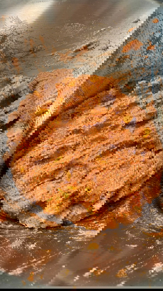 Image of In a large mixing bowl add remaining mixture except the sesame seeds and grated cheese, then mix until fully incorporated and tacky. Also, turn on the oven to 180C or 350F