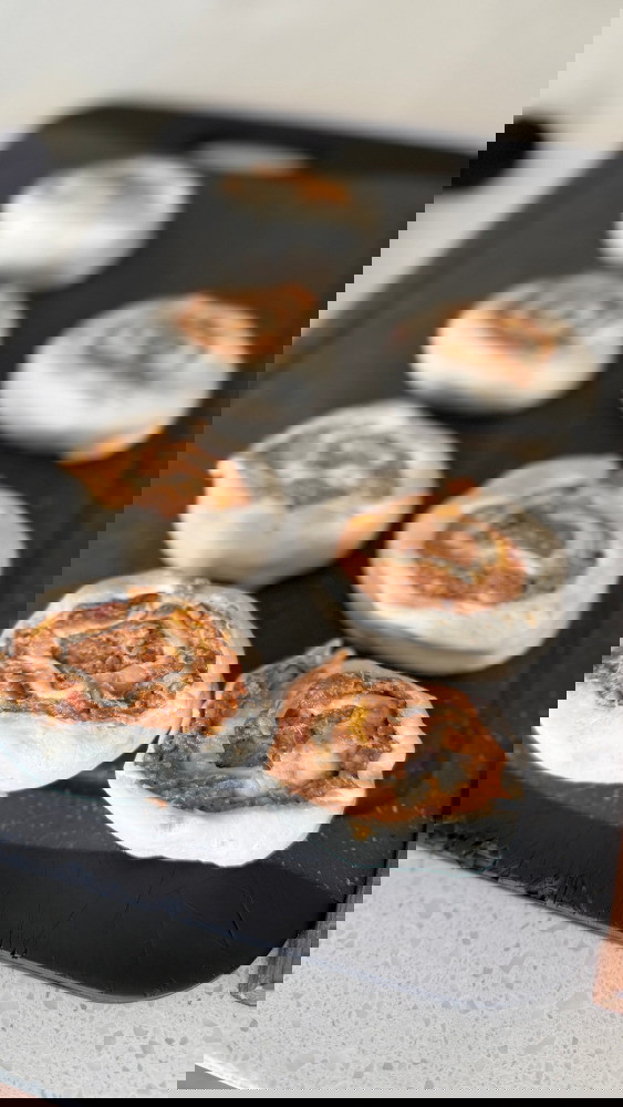 Image of from one end, roll the pastry , then use tooth floss to cut them into even pieces. 