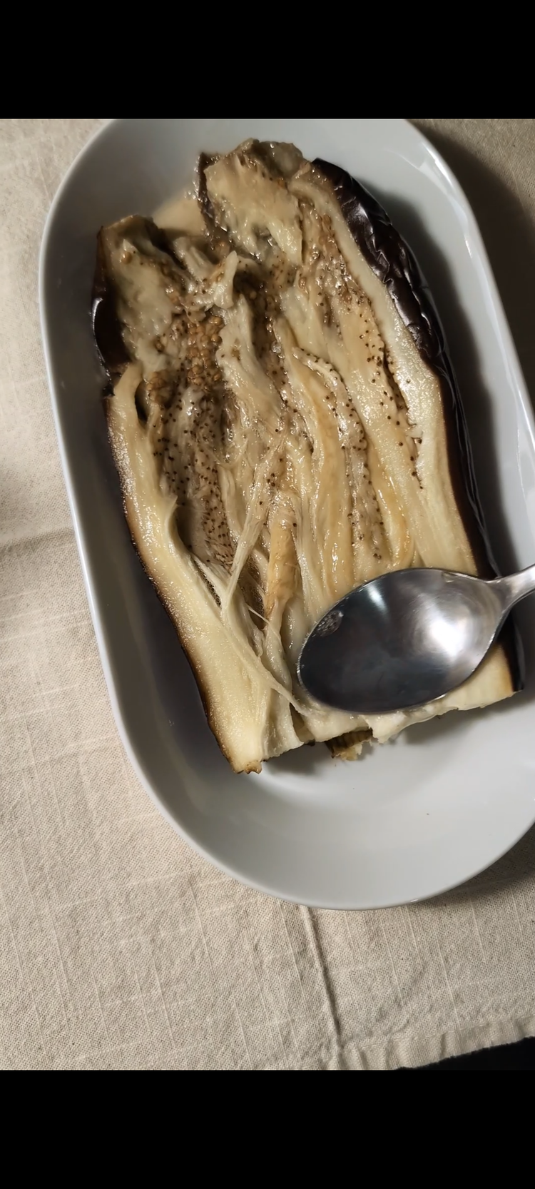 Image of Once soft, cut in half (or only top if you want to use the full eggplant for just one plate) Mash lightly with spoon until you reach desired thickness.