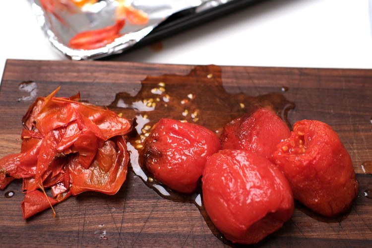 Image of Once cool to touch, peel tomato skins by hand—should come off very easily.  Gently so as not to squeeze out the liquid. Discard skins.