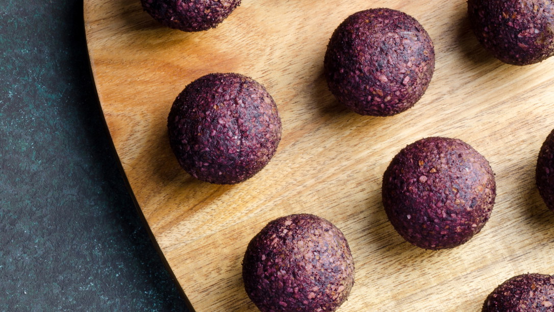 Red energy balls on a wooden board