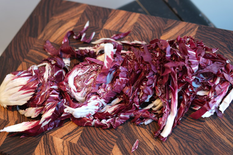 Image of Remove and toss the small lower core of the radicchio and shred the rest (think coleslaw-type cutting)